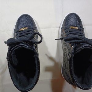 Women's Guess black quilted leather with gold Guess adornment and zippers.